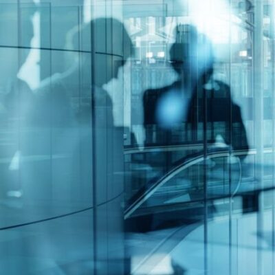 Reflection Of People On Glass Window